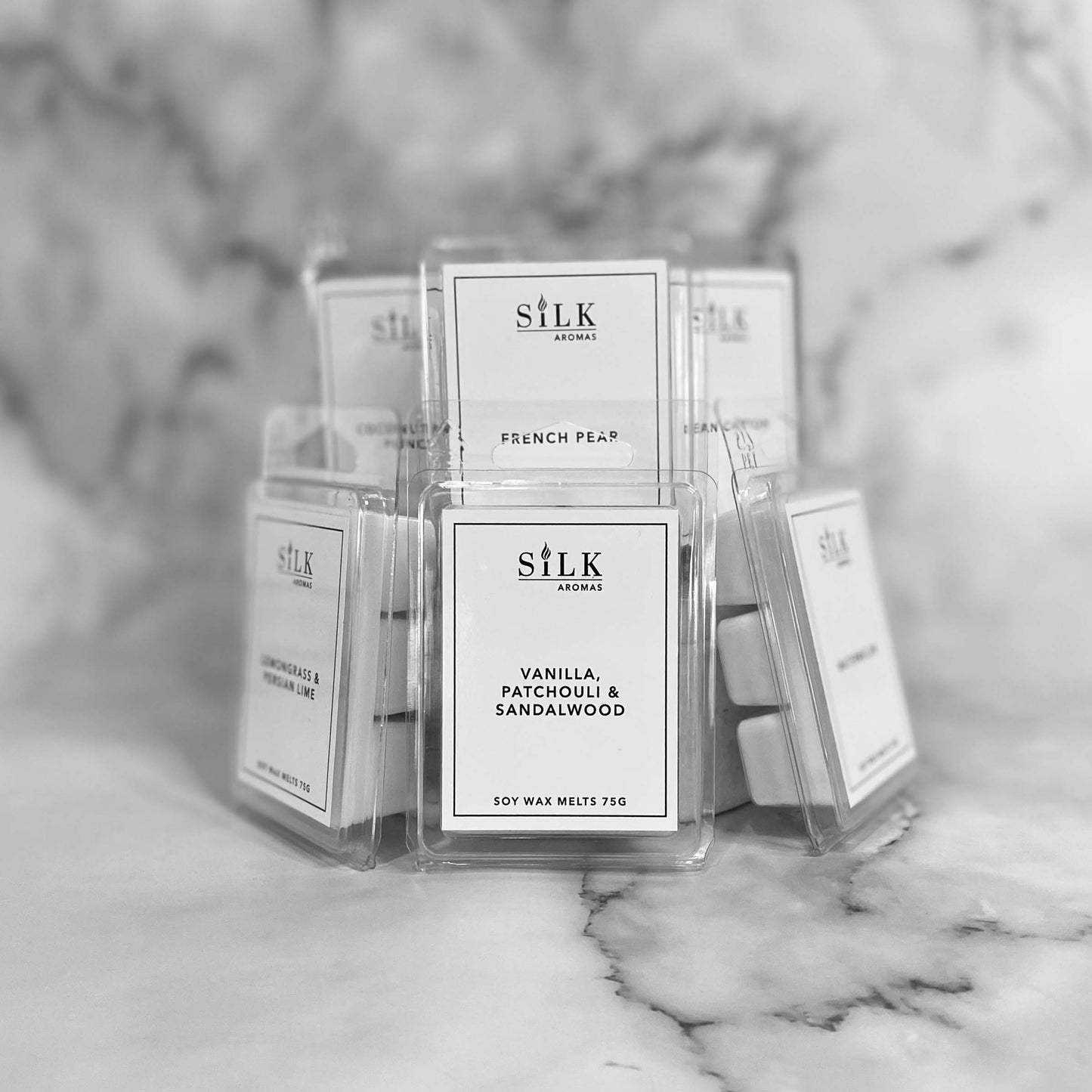 A collection of wax melt packages with white labels